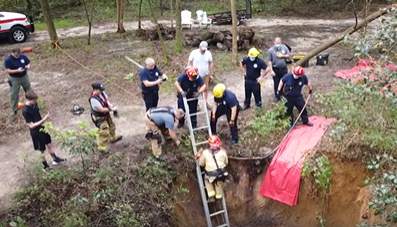 Florida fire crews rescue dog stuck in a sinkhole