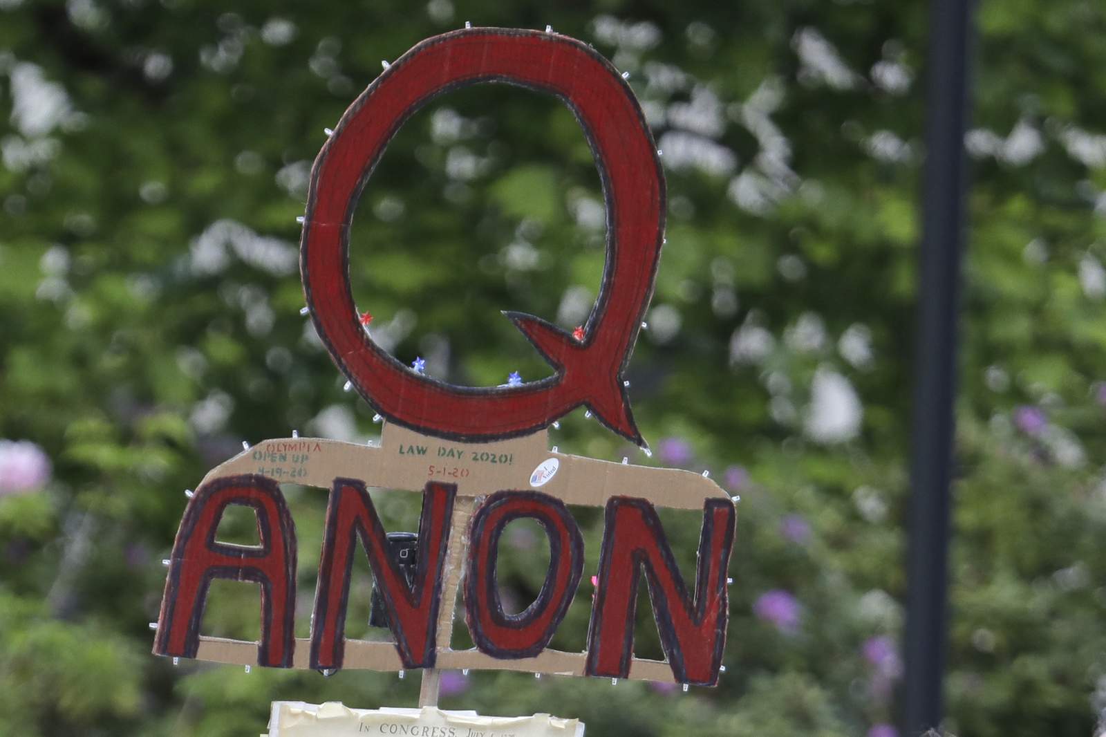 Facebook says it will ban groups that openly support QAnon