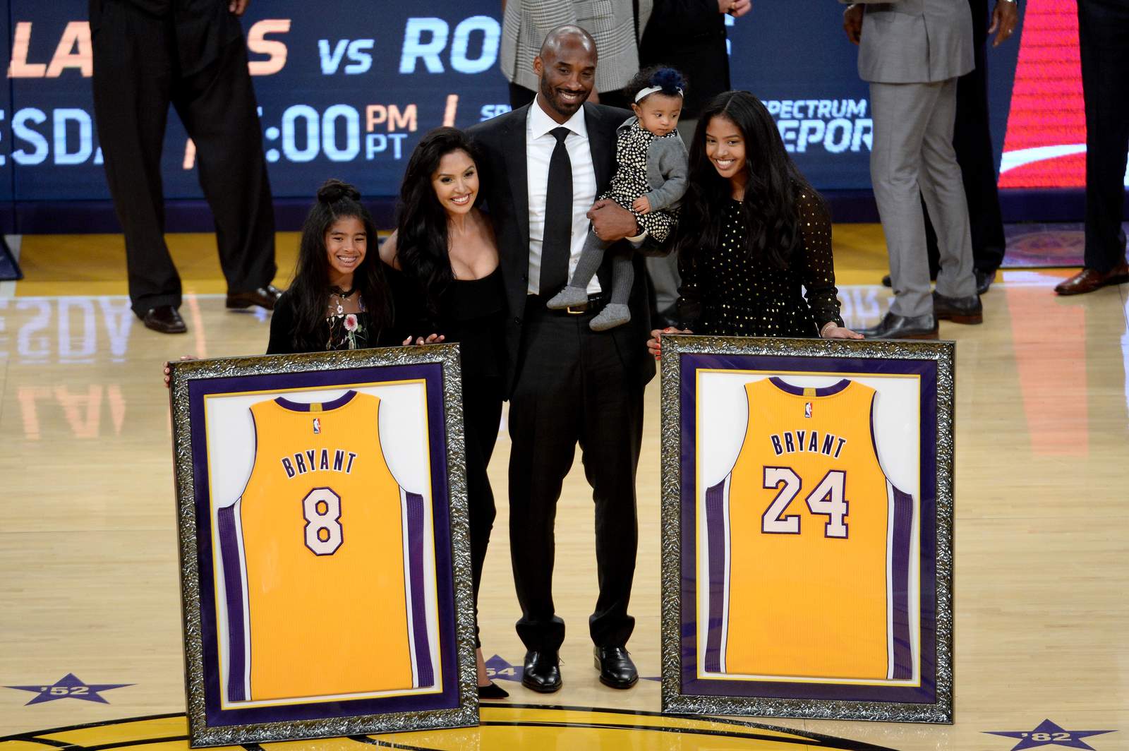 Kobe Bryant poses with his family at halftime after both his No. 8 and No. 24 Los Angeles Lakers jerseys are retired at Staples Center on Dec. 18, 2017.