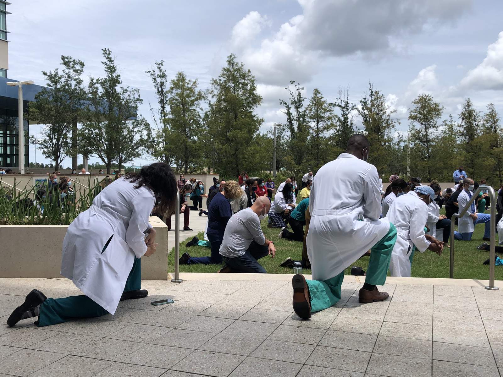 Nemours Childrens Hospital staff kneel in silence in support of White Coats 4 Black Lives movement
