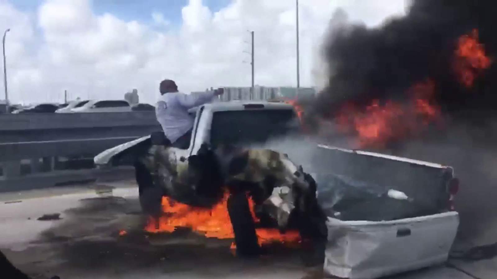 Good Samaritan jumps into action as man struggles to escape burning pickup truck