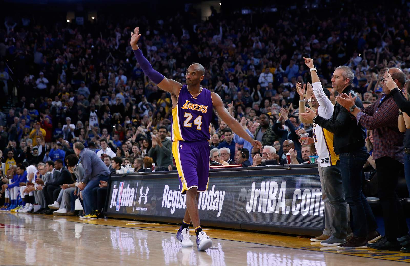 Kobe Bryant waves to the crowd after he's taken out of the game in the fourth quarter against the Golden State Warriors at Oracle Arena in January 2016.