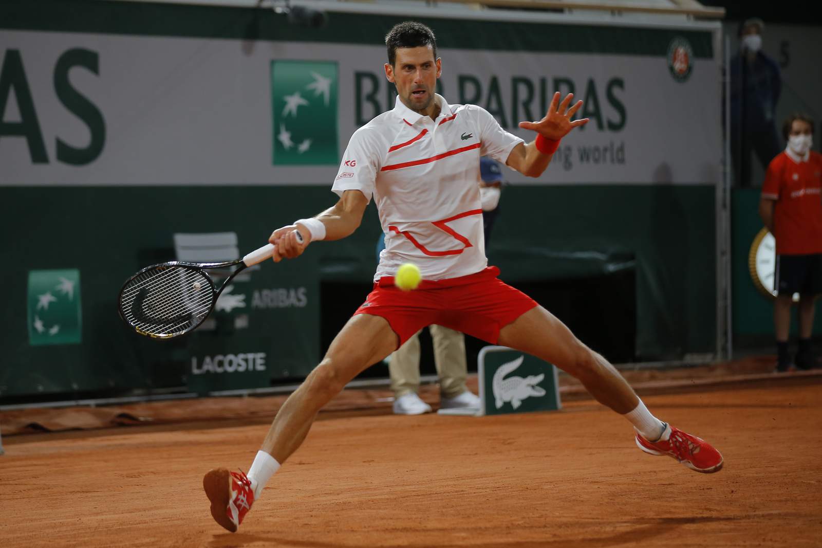 The Latest: Djokovic drops only 5 games in French Open debut