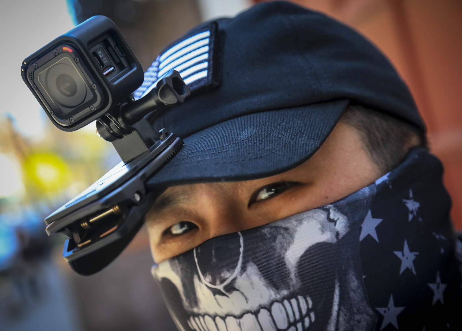 From guns to GoPros, Asian Americans seek to deter attacks