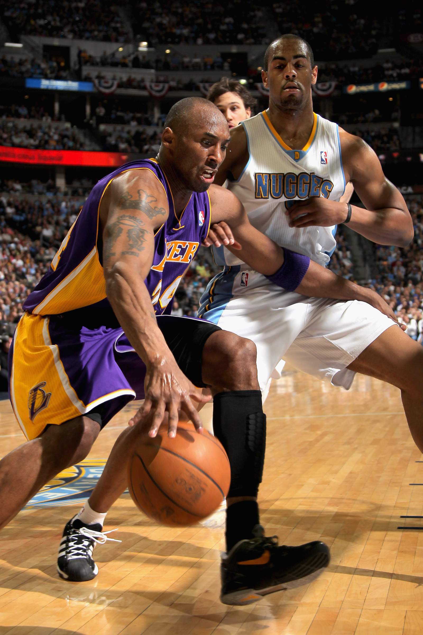 Kobe Bryant drives against Arron Afflalo of the Denver Nuggets in Game 4 of the Western Conference Quarterfinals in the 2012 NBA Playoffs at Pepsi Center.