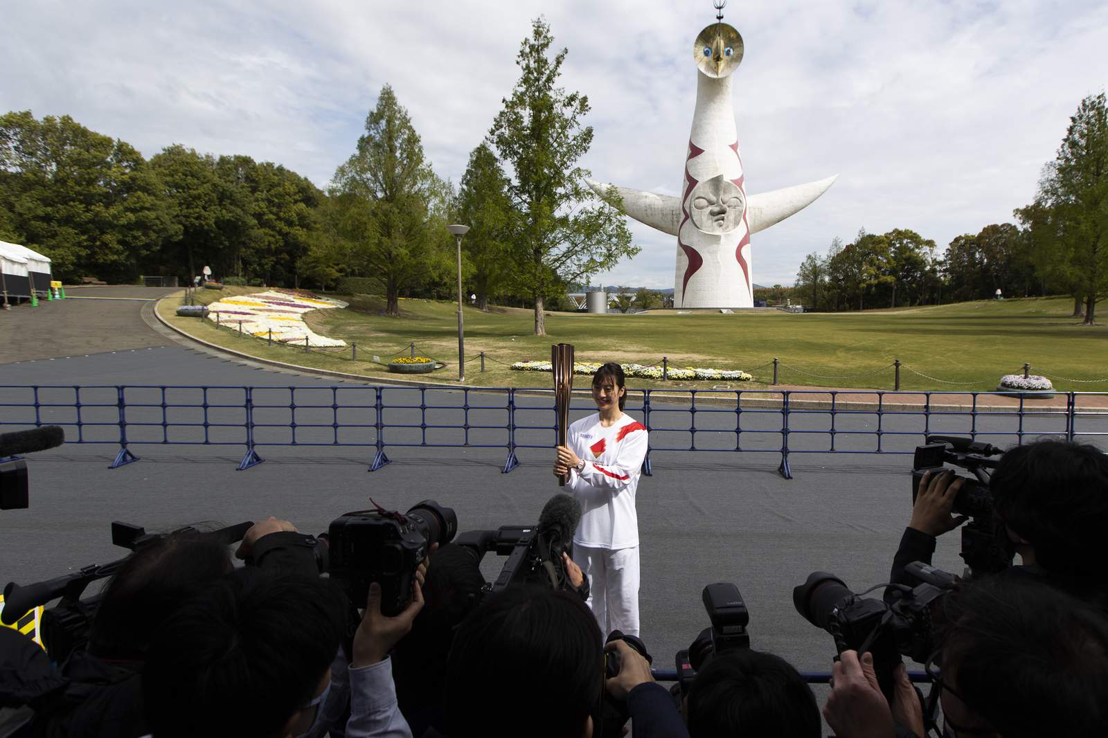 Olympic torch runs through empty park in Osaka as cases rise