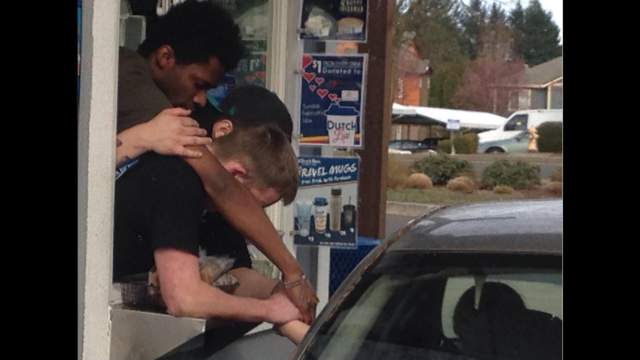 Coffee shop employees comfort grieving customer at drive-thru window