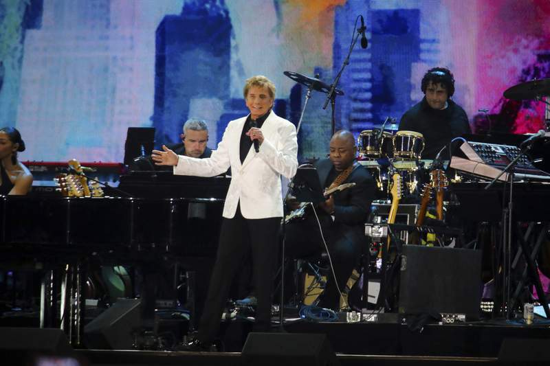 Henri cuts short Manilow set at NYC virus recovery concert