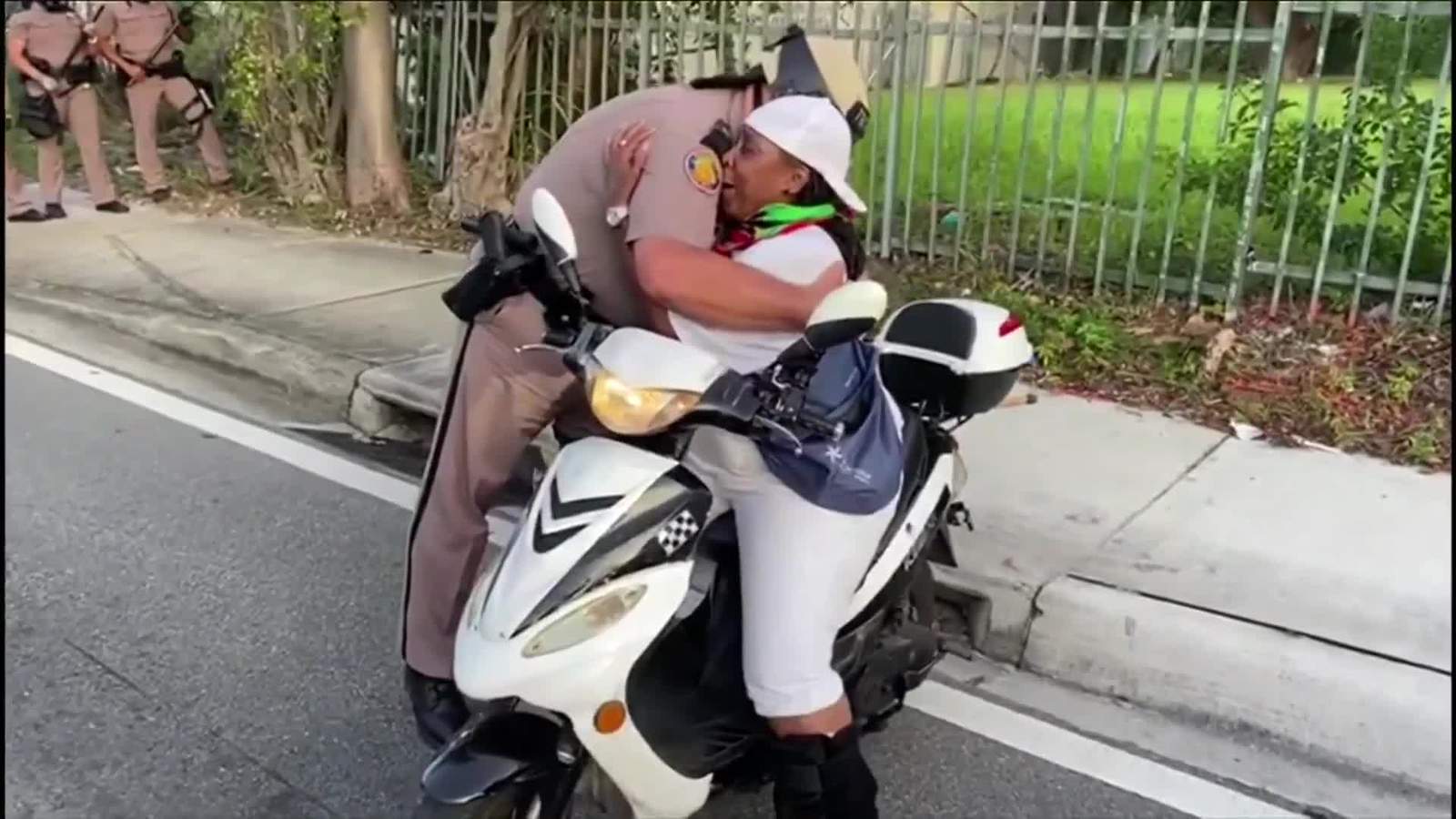 Florida trooper breaks protest line to hug woman