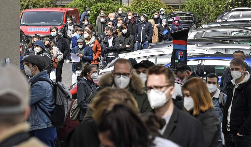 The Latest: France welcomes EU curb on AstraZeneca vaccine
