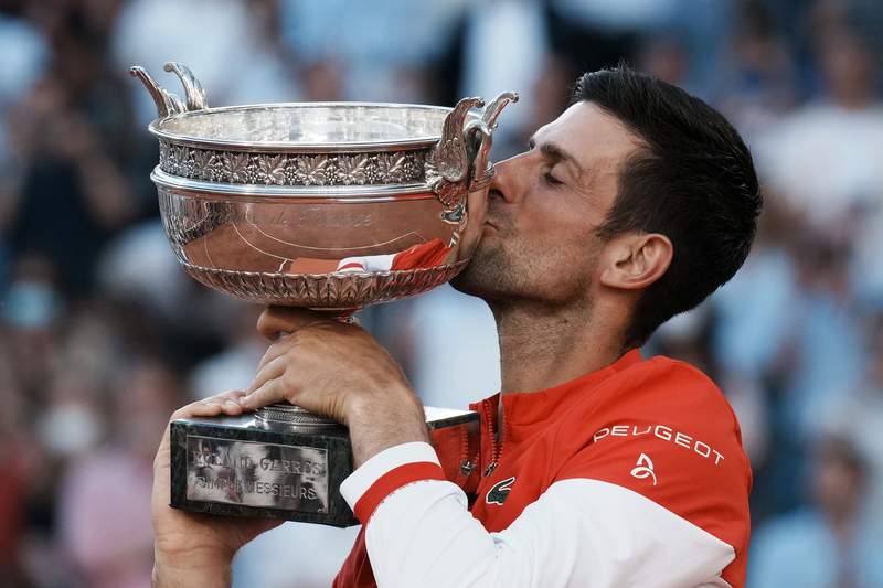 The Latest: Djokovic gives racket to supportive young fan