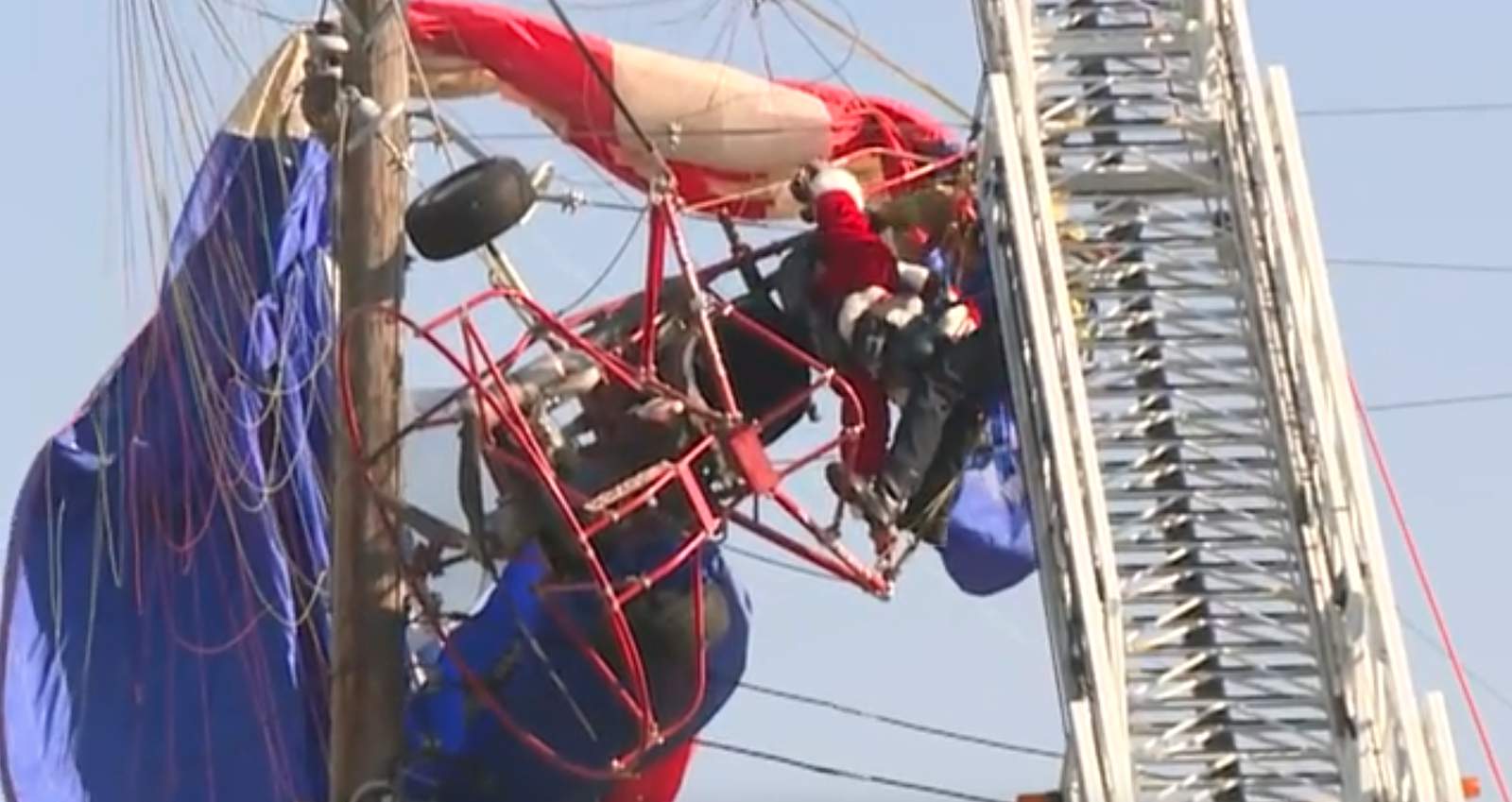 Ho, ho, no. Paragliding Santa stuck in power lines