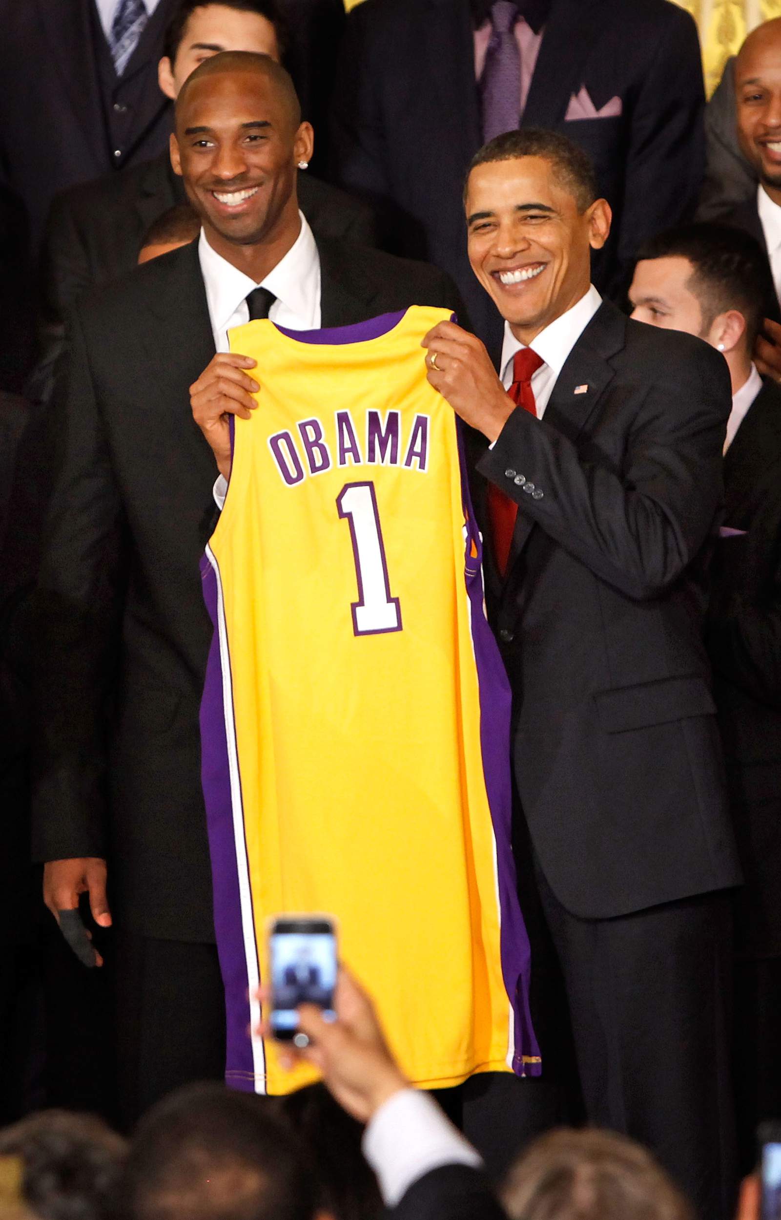 Then-President Barack Obama, at right, poses for photos with Kobe Bryant and members of the NBA 2009 champion Los Angeles Lakers -- this was taken in the East Room of the White House on Jan. 25, 2010.